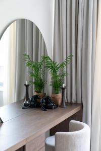 a table with two plants on it with two chairs at Athens Design Suites in Athens