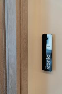 a remote control hanging on a wall next to a door at Athens Design Suites in Athens