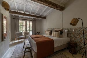 a bedroom with a large bed in a room at Les Petites Maisons - Hameau des Baux in Paradou +60 photos