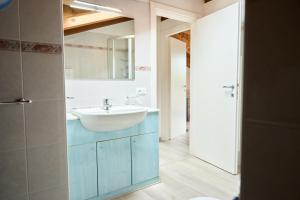 a bathroom with a sink and a mirror at Appartamenti Villa Paola-Pochi passi dal mare-Zona piazza Aurora-Lido di Jesolo in Lido di Jesolo