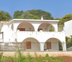 a white house with a white fence around it at La Buganvillea in Marina Porto
