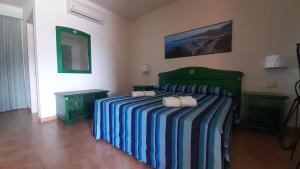 A bed or beds in a room at Le Vanille