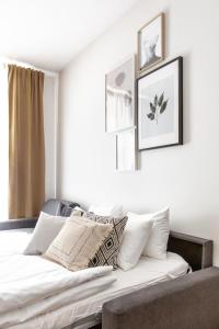a bedroom with a bed with white sheets and pillows at TurnKey I Cozy Studio by Letna Park in Prague