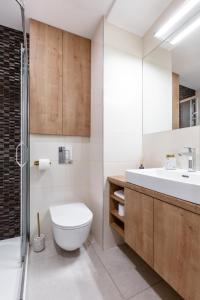 a bathroom with a toilet and a sink at TurnKey I Cozy Studio by Letna Park in Prague