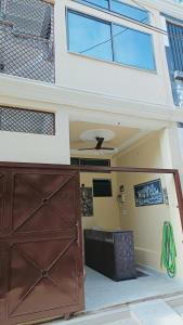 a house with a brown door in front of it at Hotel 100 Meter in Jabalpur