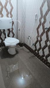 a bathroom with a toilet and a shower at Hotel 100 Meter in Jabalpur