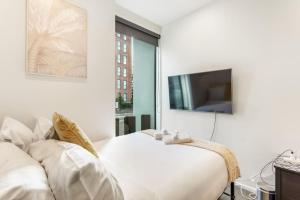 a bedroom with a bed and a flat screen tv at Cosy Studio in Central Avondale - Netflix Wi-Fi in Auckland