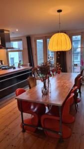 a dining room with a wooden table and chairs at Groot mooi 2 etage loft met dakterras in De Pijp. in Amsterdam