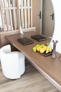 a table with a mirror and a plate of fruit on it at Athens Design Suites in Athens