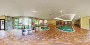 a large room with a swimming pool in a house at Courtyard by Marriott Hamilton in Hamilton