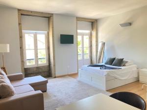 a living room with a bed and a couch at Coreto Bento Freitas in Vila do Conde