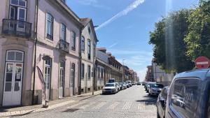 a street with cars parked on the side of the road at Coreto Bento Freitas in Vila do Conde +3 photos