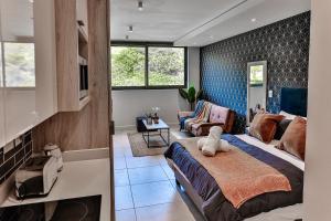 a bedroom with a king sized bed and a living room at Zimbali Lakes Boulevard Suites 218 in Ballito