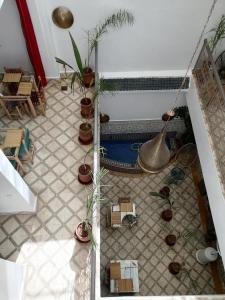 a tiled floor with potted plants in a room at Riad Papadou in Marrakesh