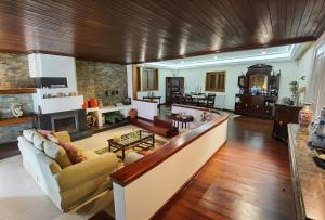 a living room with a couch and a fireplace at Casa Monte da Volta in Chaves