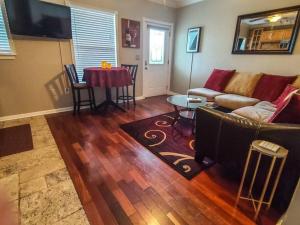 a living room with a couch and a table at Romance in the City 1 Bdrm Studio in Downtown St Pete in St Petersburg
