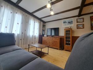 a living room with a couch and a table at COMO EN TU CASA Canfranc Estación in Canfranc-Estación +42 photos