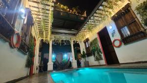 a swimming pool in the middle of a building at Baboon Hostel in Santa Marta