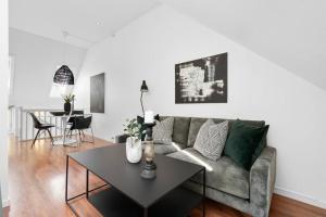 a living room with a couch and a table at Trendy townhouse in Trondheim in Trondheim