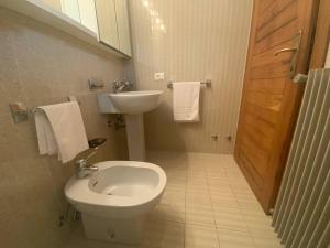 a bathroom with a toilet and a sink at Albergo Montenegro in Maniago
