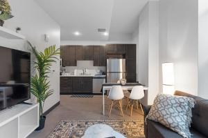 a kitchen and living room with a couch and a table at Journal Commons 325 Luxurious Cozy 1BR near Historic Third Ward in Milwaukee