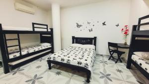 Postel nebo postele na pokoji v ubytování Hotel Beijing Cartagena