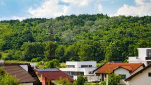 a town in front of a mountain at Natura Residence in Târgu Jiu
