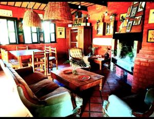 a living room with a couch and a table at LA ESTANCIA HOSTEL COLONIA in Colonia del Sacramento