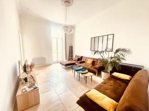 a living room with a couch and a table at NEMAUSA APARTIS in Nîmes