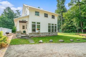 a large white house with rocks in the yard at Secluded Sunset in Glen Arbor