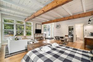 a bedroom with a large bed and a living room at Secluded Sunset in Glen Arbor