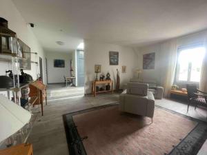 a living room with a couch and a table at 1 Appartement en Bord de Loire {Maison Bardou} in Amboise