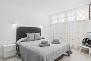 a bedroom with a bed with two pillows on it at Neptuno Ocean View, Beach line with Pool in Puerto de Santiago