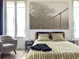 a bedroom with a bed with a bridge painting on the wall at Grande maison rénovée, 10 pers, métro 7 min, Paris centre 20 min, supermarché 100 m in Romainville