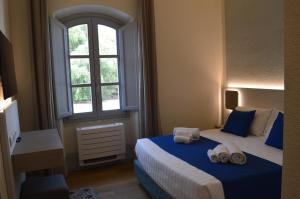um quarto com 2 camas e uma janela em TANIT ROOMS & SPA em Villasimius