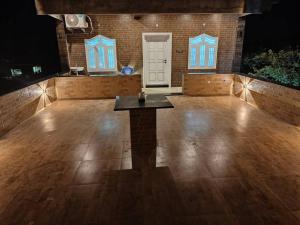 a large empty dance floor with a table in the middle at Treva Pent House in Tirunallār