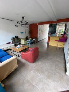 a living room with a couch and a table at República Hostel Cabin Beds in Bogotá