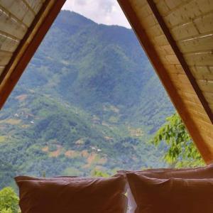 a view of a mountain from a tent with pillows at cottage panorama merisi in Inasharidzeebi