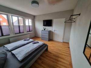 a bedroom with a bed and a television in it at Ferienwohnung zum Hufi in Dahn