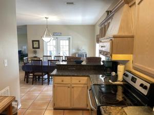 a kitchen with wooden cabinets and a dining room at 126 E Pike home in South Padre Island