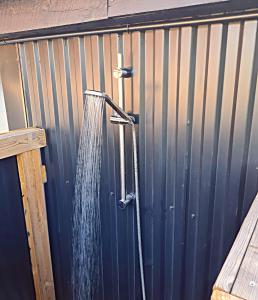 a water hose hooked up to a metal fence at Gästhus på Österlen in Tomelilla