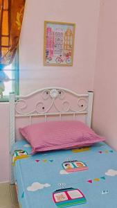 a bedroom with a bed with a pink head board at Hmsty D Hutan Kampung Alor Setar (Muslim) 