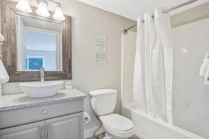 a white bathroom with a toilet and a sink at Ship Dock Lane B in Osage Beach