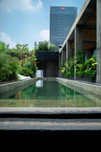 a building with a pool of water in front of it at Volga in Mexico City