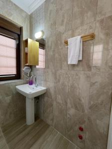 a bathroom with a sink and a tiled wall at Villa Hania Boutique Hotel - Adults only in Side