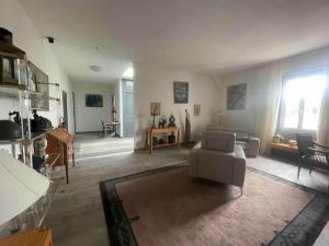 a living room with a couch and a table at Dormez Hors des 4 Temps { Maison Bardou} in Amboise