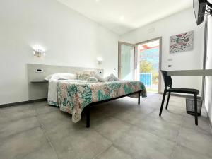 a bedroom with a bed with a chair and a window at Country & Beach Suites in Cardedu