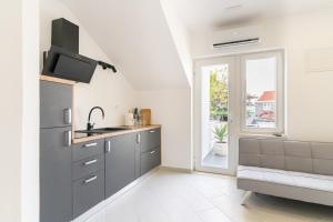 a kitchen with a sink and a refrigerator at Casa De Hijos in Cavtat