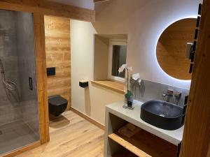 a bathroom with a black sink and a shower at GITE La fromagerie Haut Jura in La Mouille +26 photos