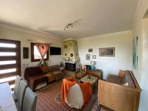 a living room with a couch and a table at Aerino House in Dassia